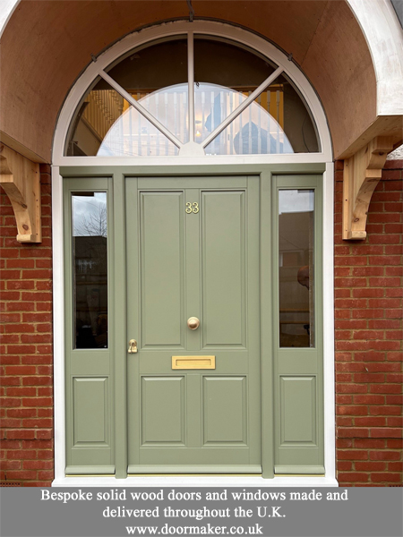 victorian front door with arched toplight and side panels