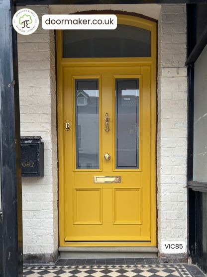 yellow victorian front door 2 over 2 with toplight