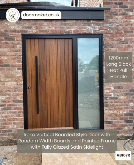 Contemporary Front Door with Vertical Random Width Boards and Black Frame
with Satin Sidelight – Made from Iroko Ref. VB107R