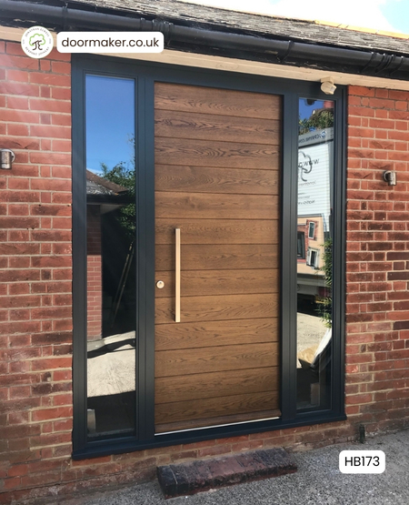 contemporary horizontal boards door and frame withsidelights. Door finish medium oak - frame Anthracite Grey