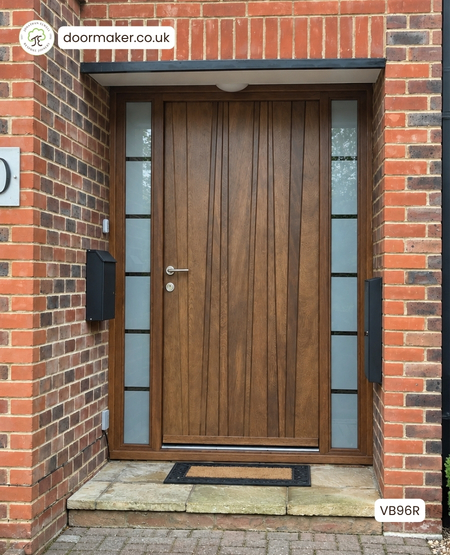 modern entrance door made from Iroko with vertical diagonal boards and frame with etched line sandblast glass
