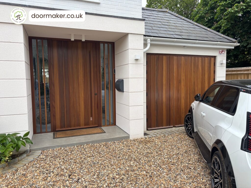 iroko contemporary door with raised batten design and matching garage doors