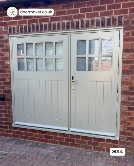 Hardwood garage doors with multiple glass panes, one fixed door and one opening